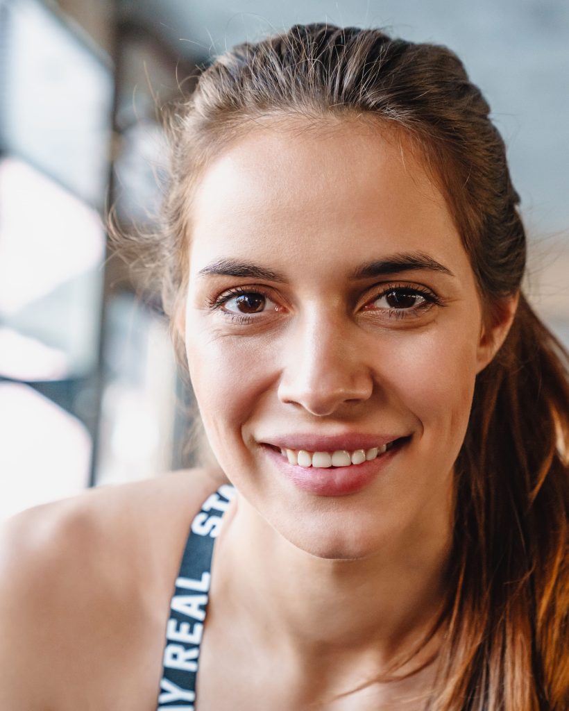 portrait-of-cheerful-nice-sportswoman-smiling-and-2026-01-09-00-04-05-utc (1) (1)